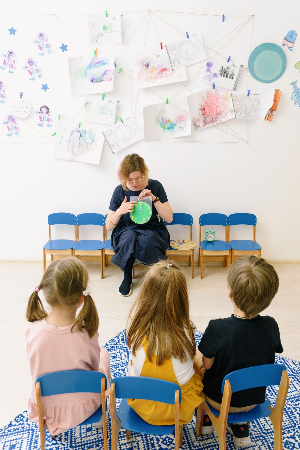 Teacher leading children in a classroom circle-time activity