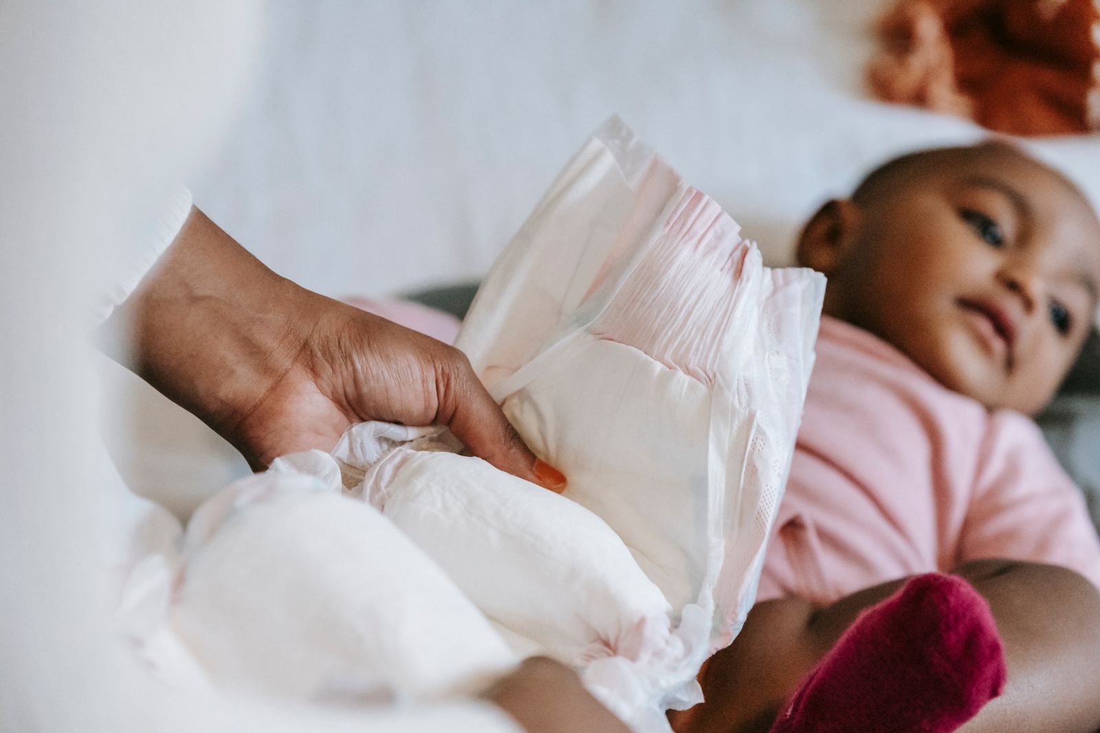 Caregiver gently caring for a baby in a cozy, bright room