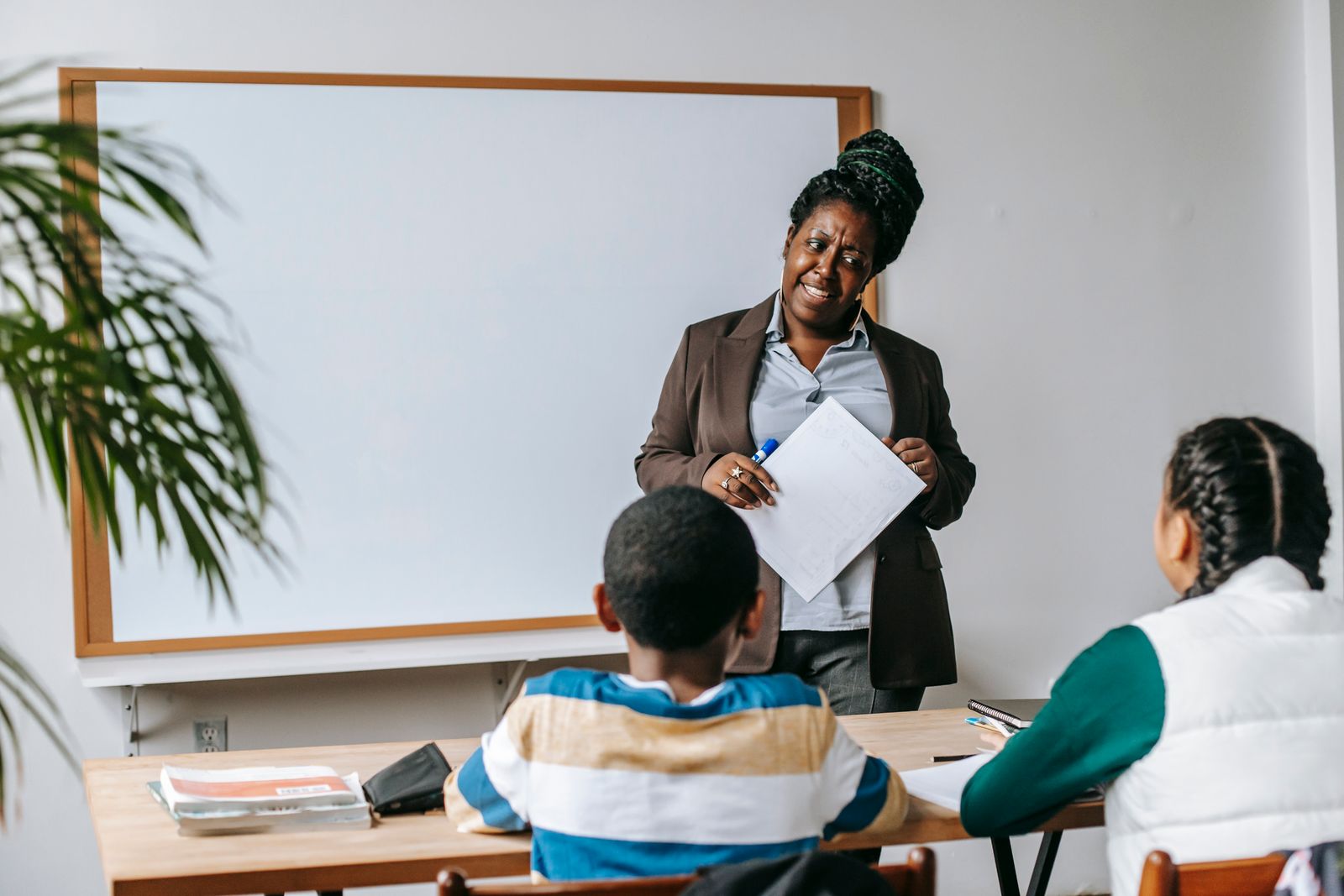 Teacher leading a lesson with school-age students at the board