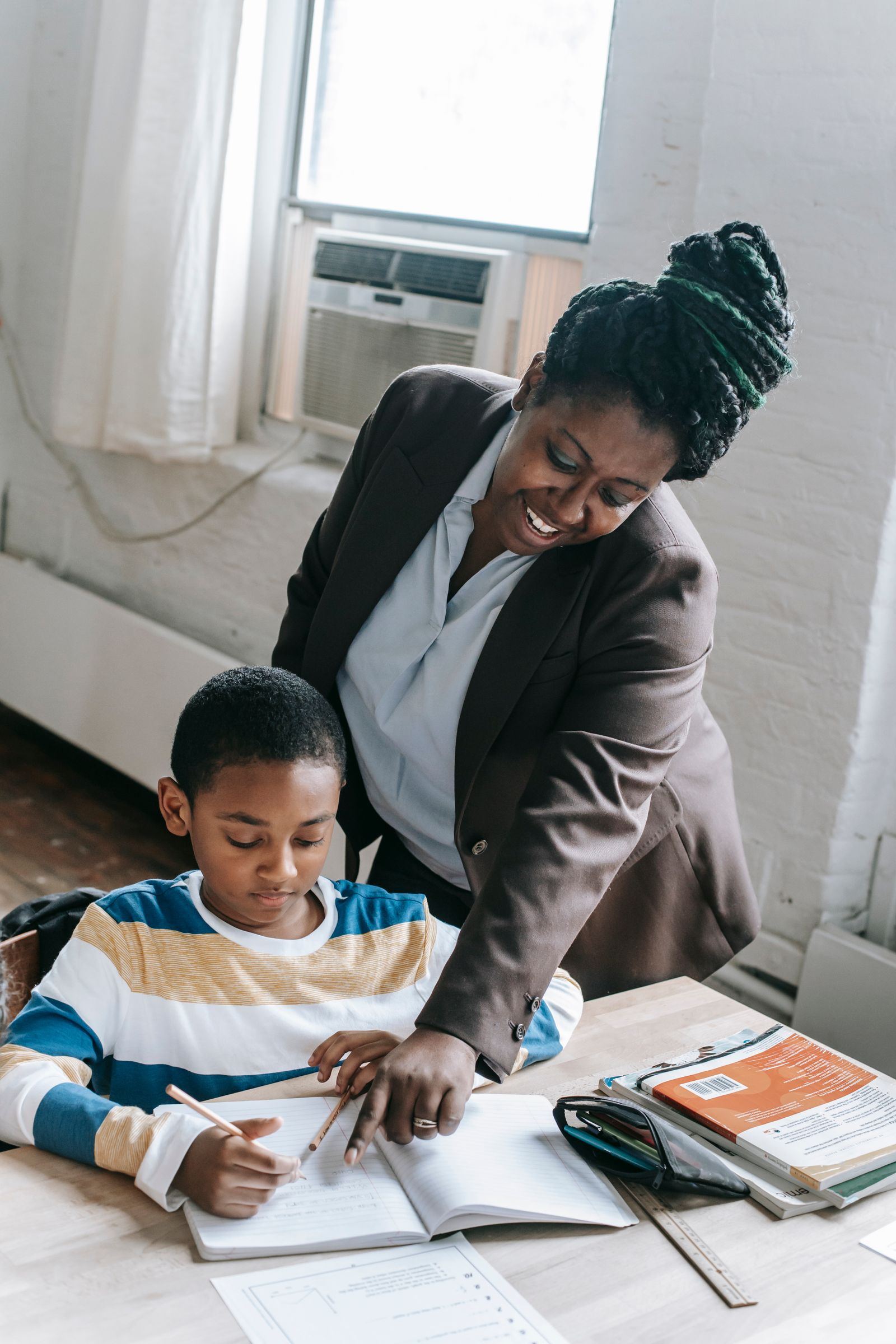Teacher encouraging a toddler one-on-one in the classroom